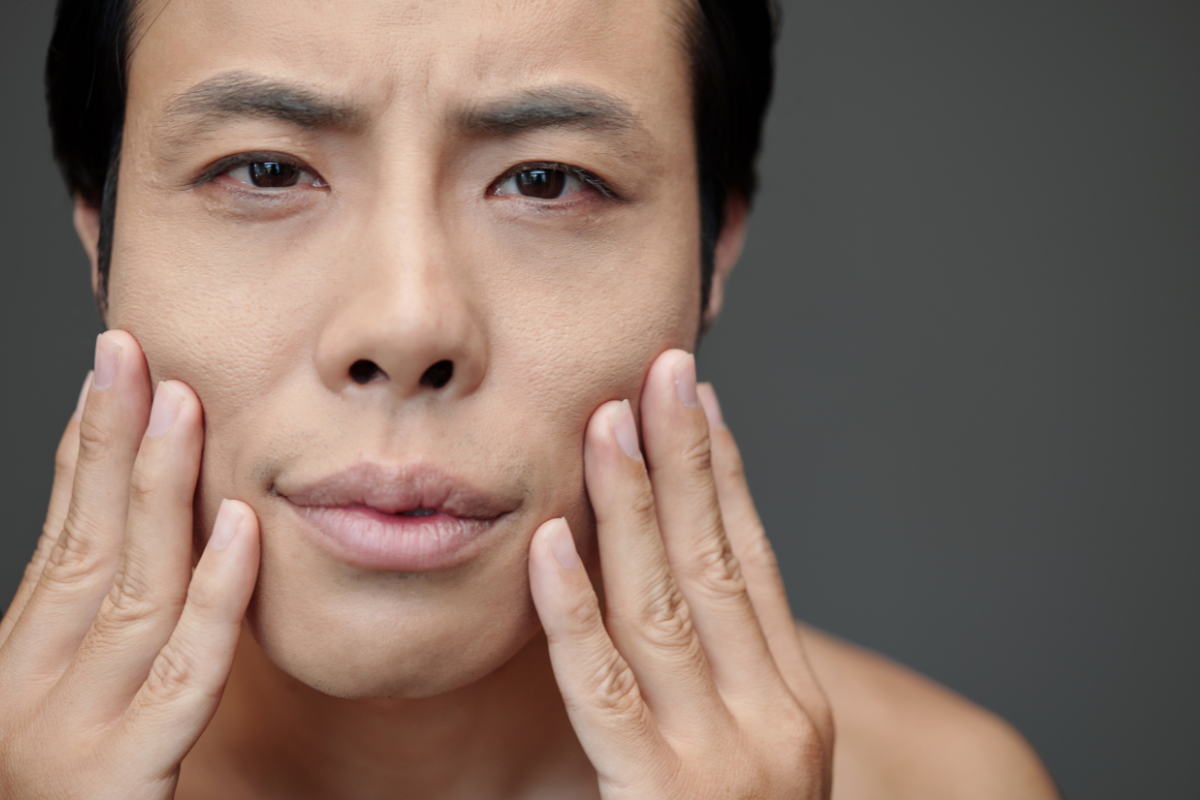 A man experiencing facial pain in the Cayman Islands.