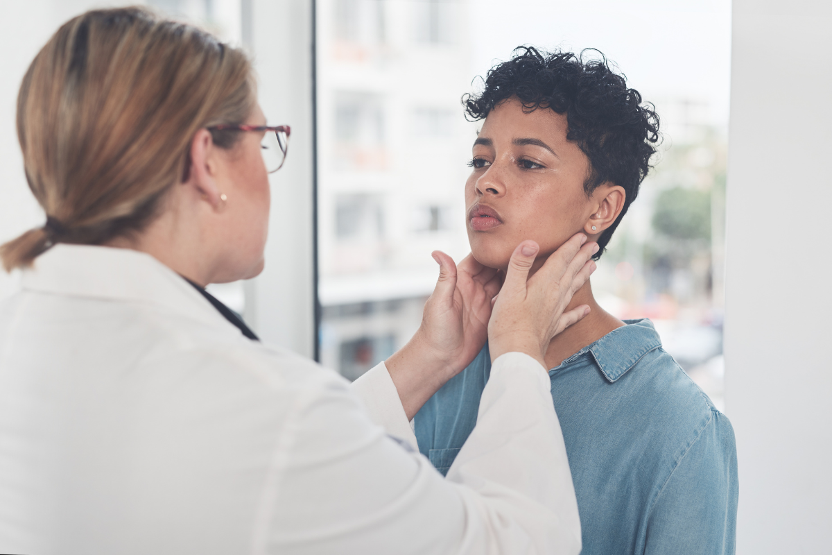 A doctor examining a patient with jaw pain before administering a neurotoxin injection in the Cayman Islands.